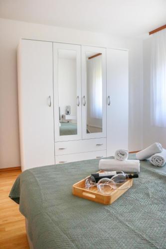 a bed with a wooden tray on top of it at Kuća za odmor Franca in Ozalj