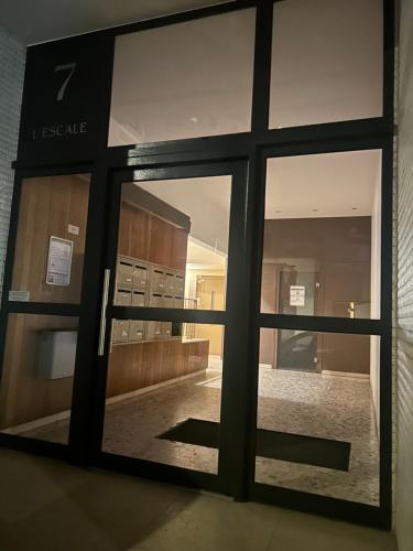 a view through a glass door of a building at L'Escale Gare Châteaucreux avec Garage in Saint-Étienne