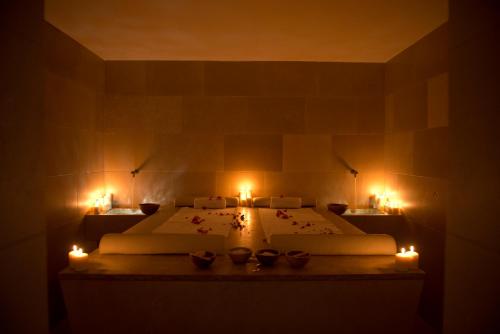 a room with two beds with candles in it at Relais Histò San Pietro Sul Mar Piccolo in Taranto