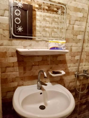 a bathroom with a white sink and a mirror at King Siwa in Siwa