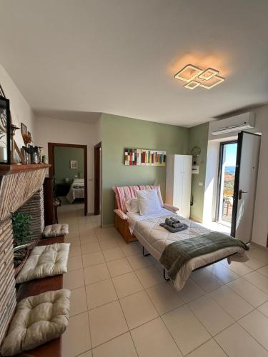 a living room with a bed and a fireplace at Silent Lake View in Valentano