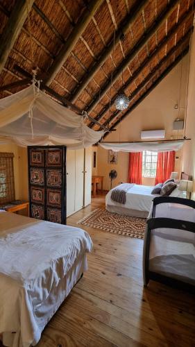 a large bedroom with two beds in a room at Namagong in Marloth Park