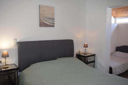 a bedroom with a bed and two night stands at Casa de la Serenidad in Mazarrón