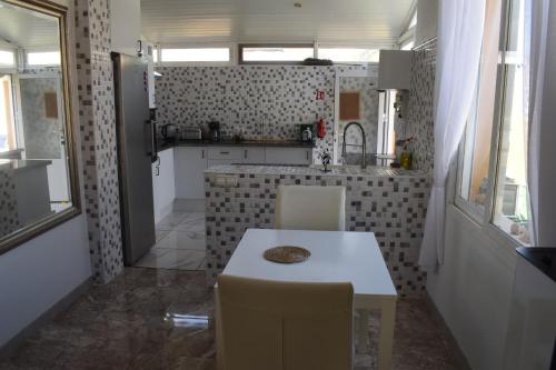 a small kitchen with a table and chairs in it at Casa de la Serenidad in Mazarrón