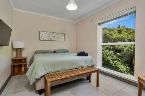 a bedroom with a bed and a large window at Villa Oceanic Escape in Hout Bay