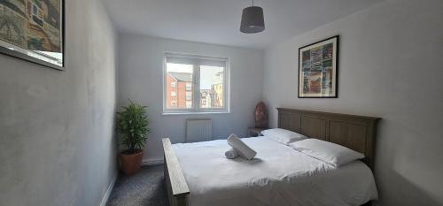 a bedroom with a bed with a pillow on it at Principality, WMC, Utilita Arena in Cardiff