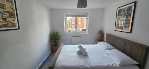 a bedroom with a white bed with a window at Principality, WMC, Utilita Arena in Cardiff
