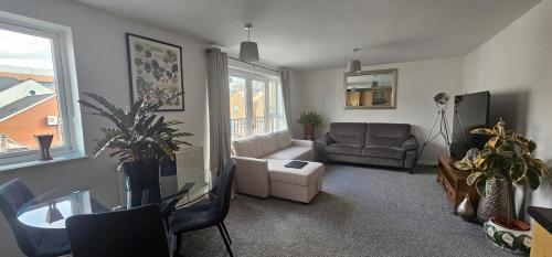 a living room with a couch and a table at Principality, WMC, Utilita Arena in Cardiff
