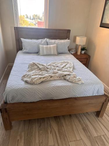 a bed with a blanket laying on top of it at Ekaya in Fremantle