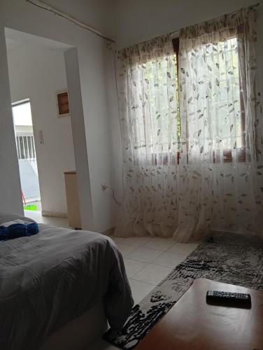a bedroom with a bed and a window with curtains at Summer House 96 in Salamina