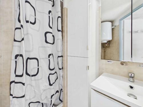 a bathroom with a sink and a shower curtain at Studio cabine mezzanine 6 pers avec parking privé - FR-1-326-403 in Marseillan