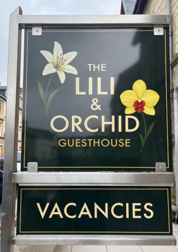 a sign for the lily and orchiducourageemetery at The Lili & Orchid Guesthouse in Oban