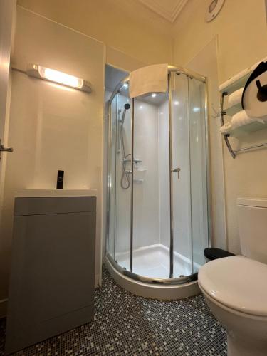 a bathroom with a shower and a toilet at The Lili & Orchid Guesthouse in Oban
