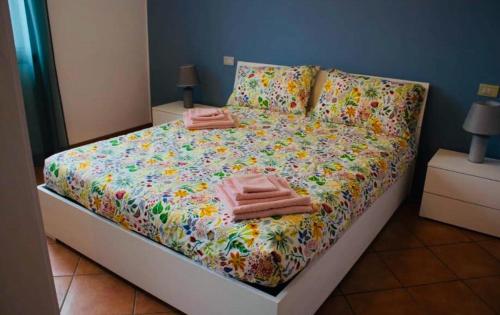 a bed with two pink towels on top of it at AR House in Clusane sul Lago
