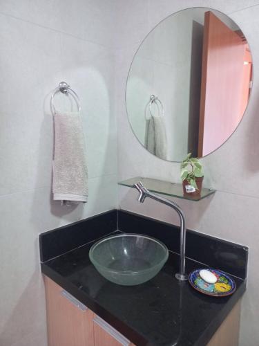 a bathroom with a sink and a mirror at Villas House - Praia Formosa - Cabedelo in Cabedelo