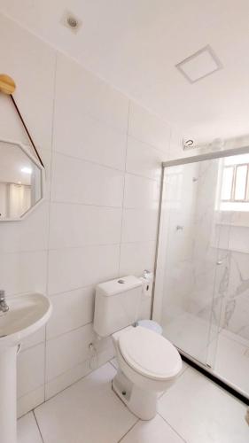 a white bathroom with a toilet and a shower at Labonita House - Pilar in Itamaracá