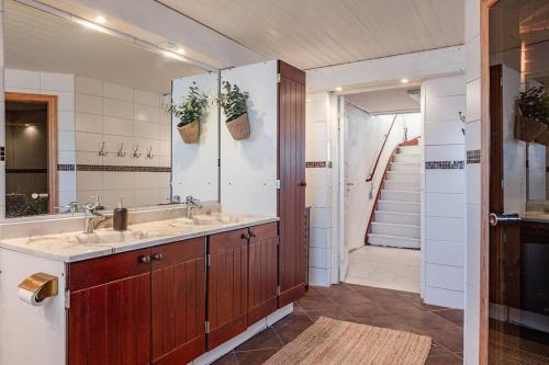 a bathroom with a sink and a mirror at Slätterne Gård B&B in Sandviken