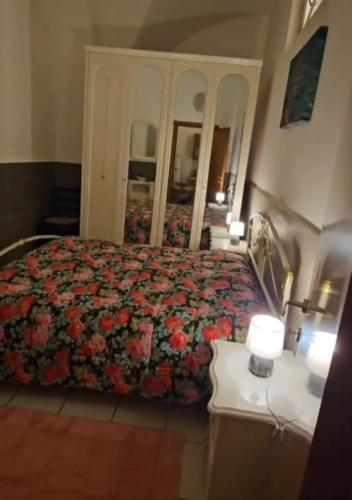 a bedroom with a bed and a dresser and a mirror at Nonna Ninetta - Locazione Turistica in Orta Nova