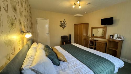 a hotel room with a bed and a desk with a computer at The Coach House in Melbourne