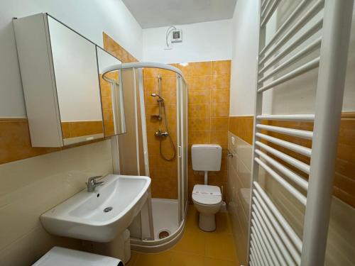 a bathroom with a sink and a toilet and a shower at Riviera Appartament in Grado