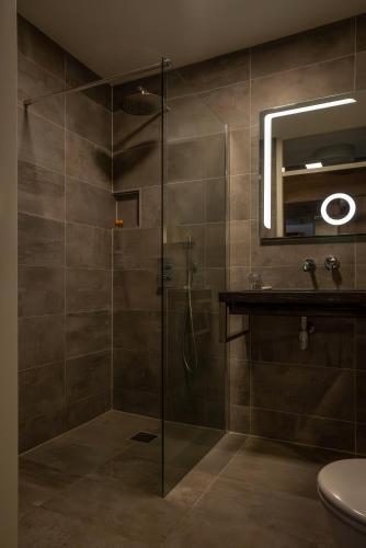 a bathroom with a shower with a glass door at ART Hotel Rotterdam-Fully Renovated in Rotterdam