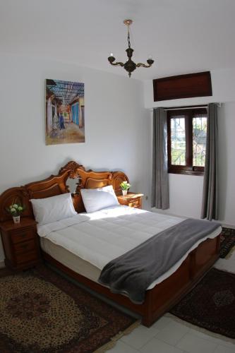 a bedroom with a large bed in a room at Cozy Central Nahda in Rabat