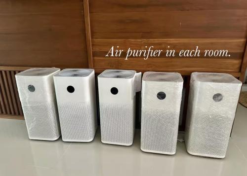 a row of four toilet paper dispensers sitting on a floor at My happy place in CNX in Chiang Mai