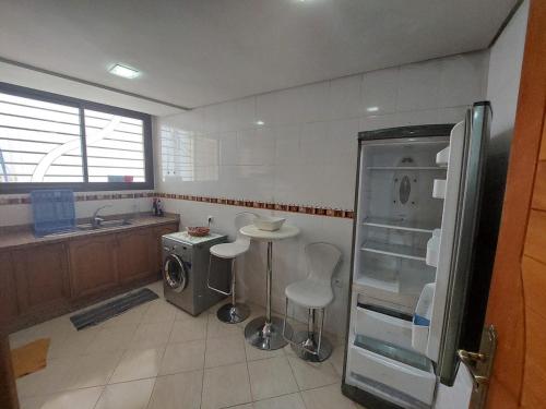 a kitchen with a sink and a refrigerator and a counter at Apartment Hamria Meknes in Meknès
