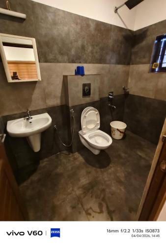a bathroom with a toilet and a sink at Vagamon Hill Chimes in Vagamon