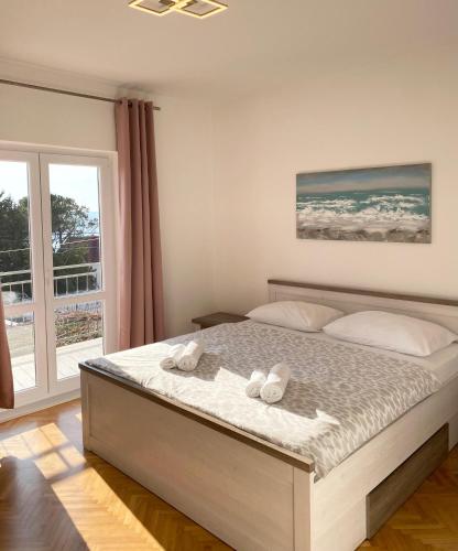 a bedroom with a bed with two towels on it at Apartment Duda in Starigrad