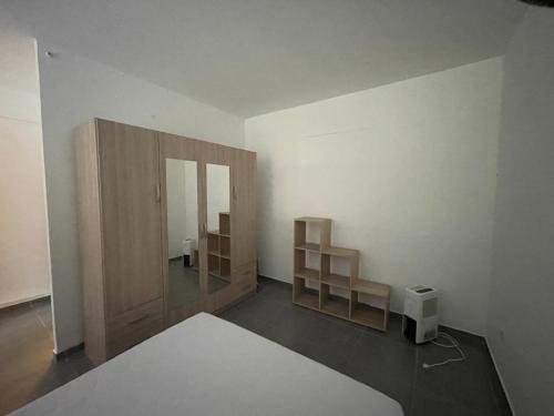 a room with two wooden shelves and a mirror at U limone 2 in Grosseto-Prugna
