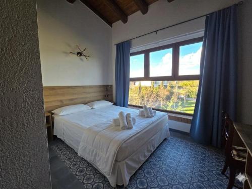 a bedroom with a bed and a large window at Agriturismo Maison Oro Verde in Verona
