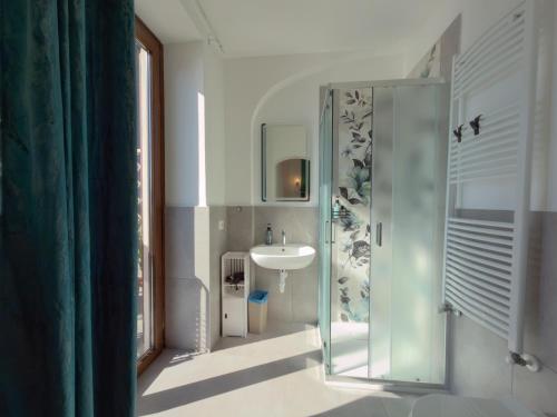 a bathroom with a glass shower and a sink at Villa Angelina - Lake View Dreams in Cannero Riviera