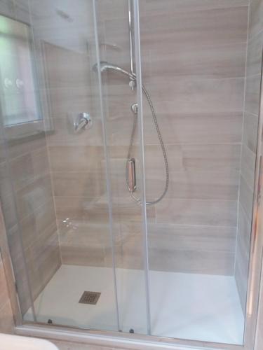 a shower stall with a glass door with a shower at Casa Cinzia Bonassola Cinque Terre in Bonassola