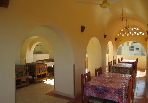 a dining room with a table and chairs in a room at Kareem Hotel Luxor in Luxor