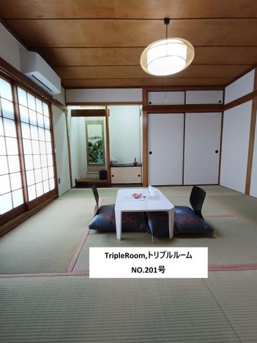 a room with a table and chairs in it at women only 女性専用 しげの里松福 in Takamatsu