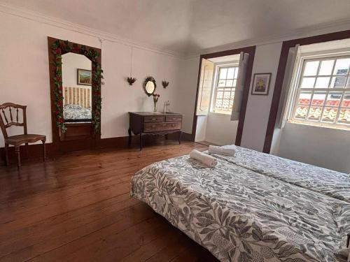 a bedroom with a bed and a dresser and a mirror at Esposende Garden in Esposende