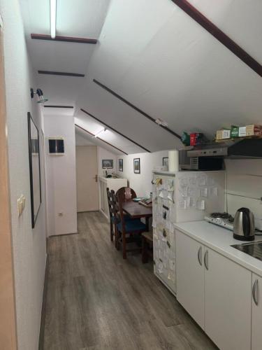 a kitchen with a table and a dining room at Hostel FM in Mostar