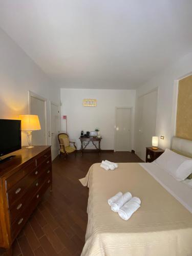 a bedroom with a bed with two towels on it at Sparano 51 in Bari