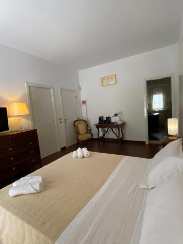 a bedroom with a large bed with towels on it at Sparano 51 in Bari