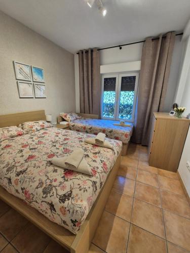 a bedroom with two beds with hats on them at 1 Duplex Las Terrazas Cubes in Vélez de Benaudalla