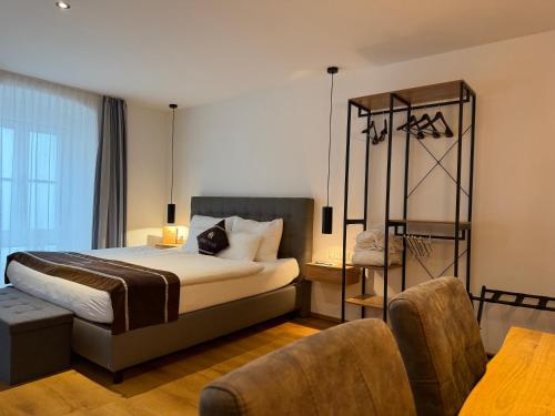a hotel room with a bed and a chair at stadtwirt bruck in Vöcklabruck