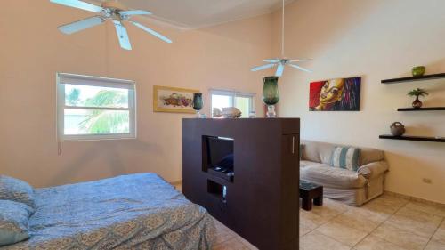 a living room with a tv and a couch at Ocean Dream Beachfront Studio with Balcony in Cabarete