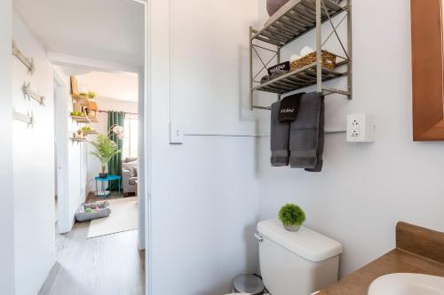 a small bathroom with a toilet and a hallway at Spring Escape 1BR by UA DT Just 2 Min to Banner in Tucson