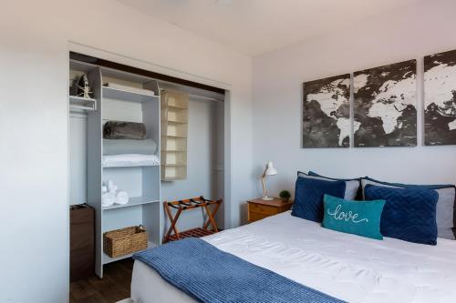 a bedroom with a bed with blue pillows at Spring Escape 1BR by UA DT Just 2 Min to Banner in Tucson