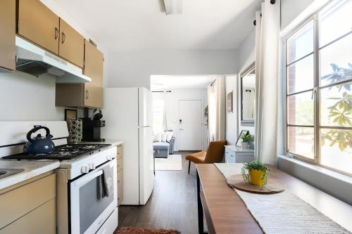 a kitchen with a stove top oven next to a living room at Spring Escape 1BR by UA DT Just 2 Min to Banner in Tucson