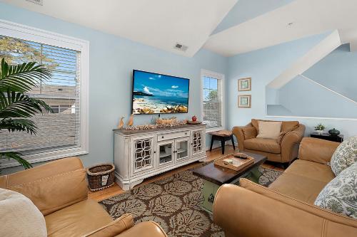 a living room with couches and a tv at 14111 Fiesta Rd - Cape Canoe in Ocean City