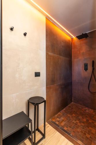 a bathroom with a stool and a shower at Sassolino Dimora Storica in Matera