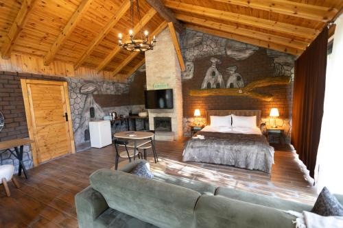 a bedroom with a bed and a couch in a room at Eymirbungalovya in Yeşilkent