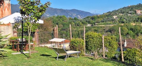 a table and a chair sitting in the grass at Casa del contadino in Rapallo